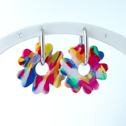 Video of colorful flower-shaped earrings with 316L surgical stainless steel oval hoops on a white background